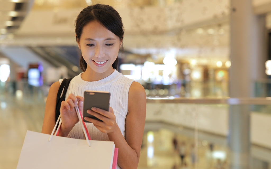 Woman On Smartphone Shopping In a Mall | Frank Mobile Australia